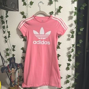 This is a bright pink kids dress and is from adidas.